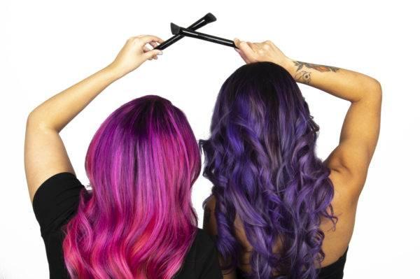Women posing with hair color brush